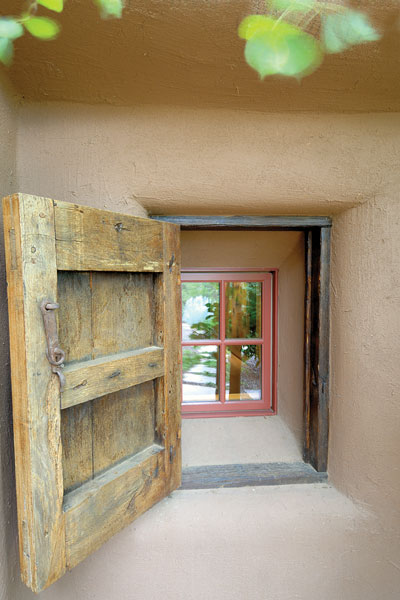 A locally crafted faux-antique door opens to reveal a window looking inside.
